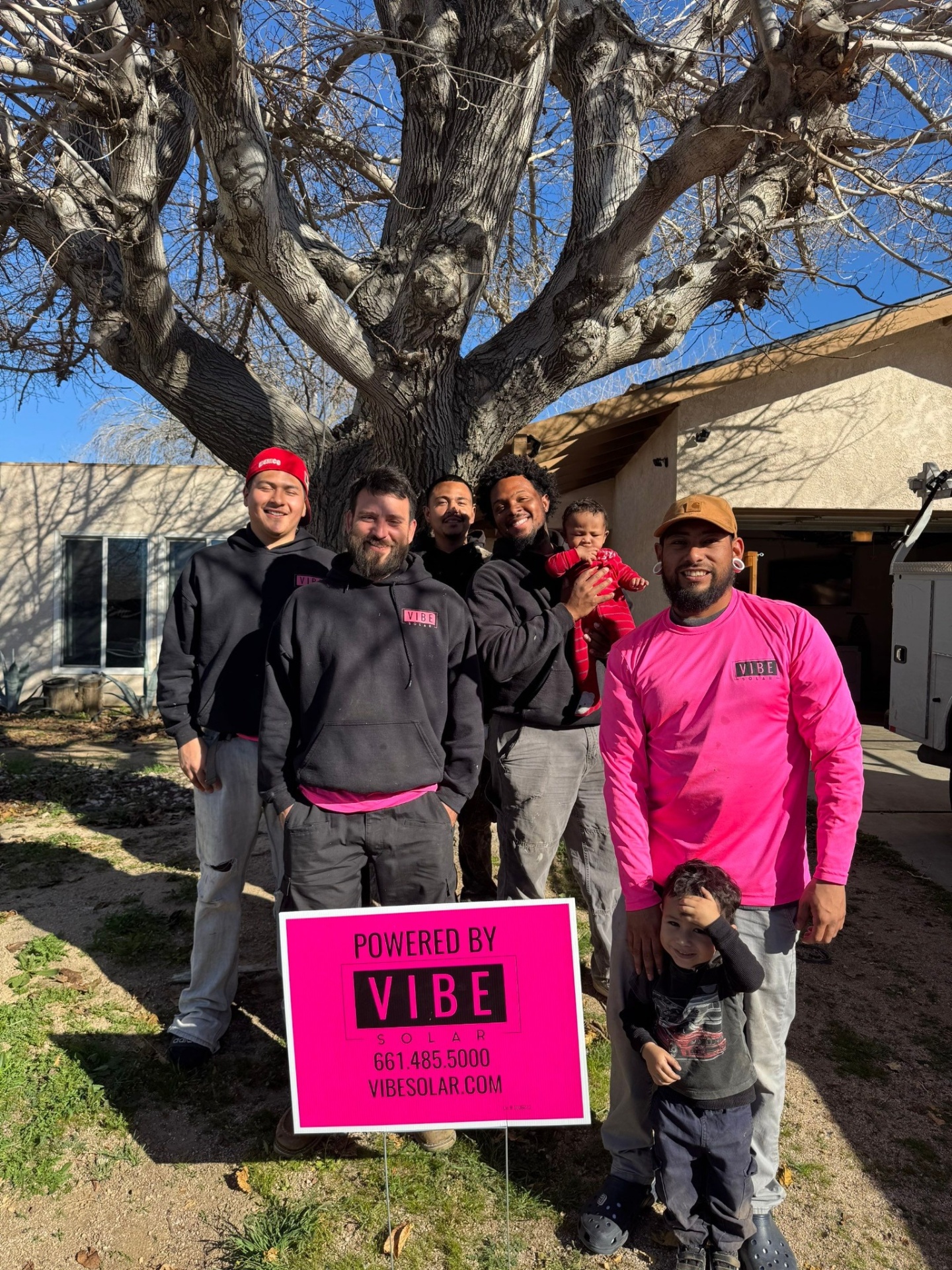 Vibe Solar install team celebrating with a customer's family
